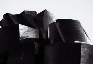 Abstract architectural silhouettes in black and white with angular geometric shapes.