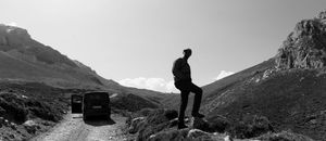 Silhouettes of mountains create a dramatic black and white panoramic landscape view.