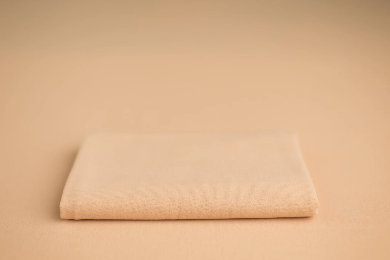 Light peach tones newborn photo backdrop and wrap sample for baby portraits.
