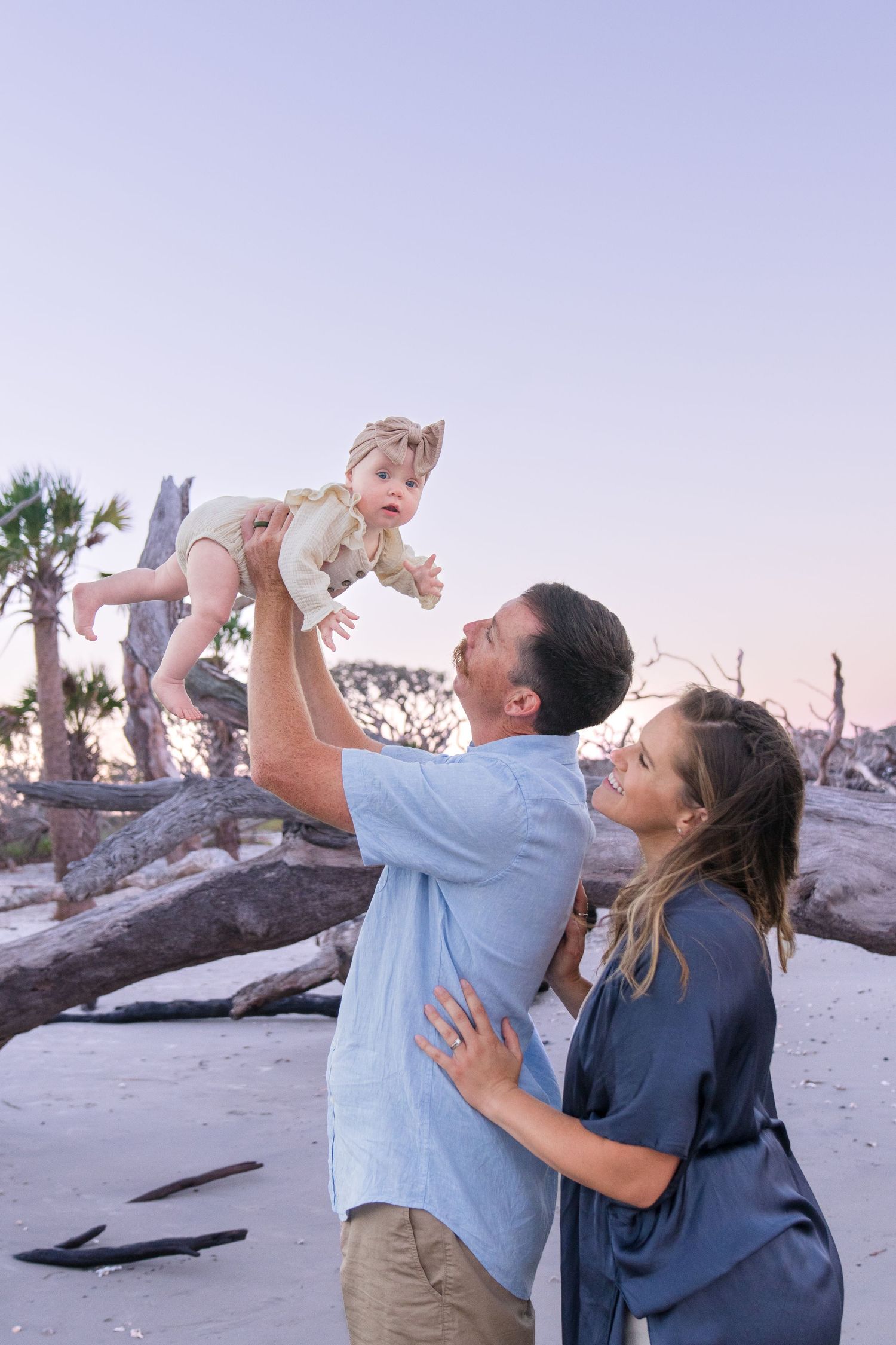 Golden hour portraits on driftwood beach of a family during their Jekyll Island vacation weekend getaway