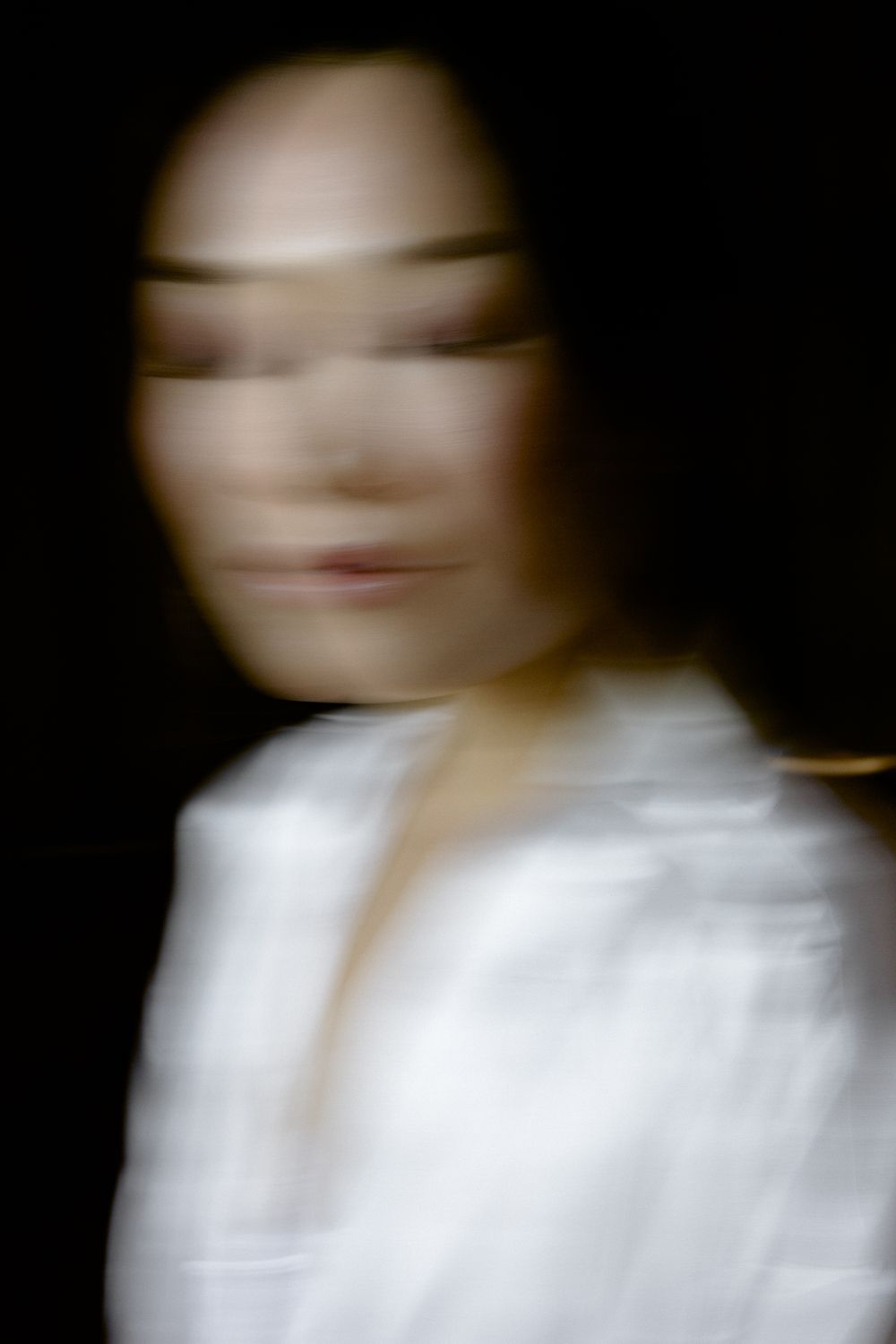 Artistic blurred portrait in white against dark background creating ethereal effect. Pyrgos Petreza, Athens.
