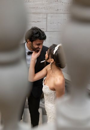 Intimate moment between bride and groom during wedding photoshoot through soft focus lens.