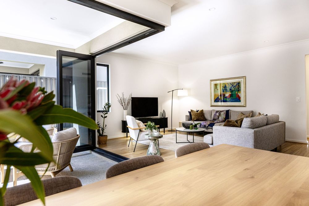 Photographer Kirsten Graham photographs a modern living room interior with large sliding glass doors, letting in gorgeous natural light.