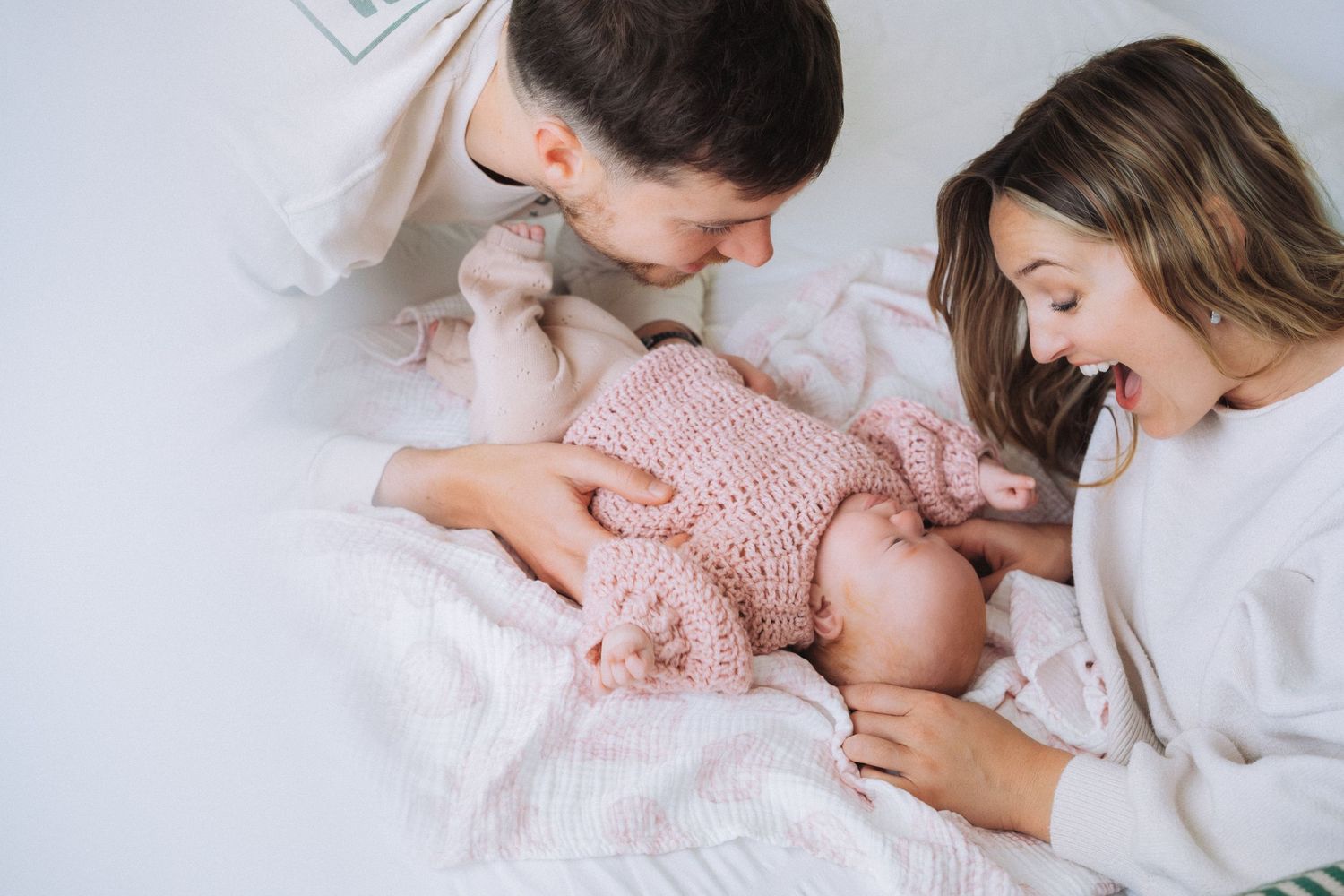 Newborn Photography - Mom and Dad with baby on bed at their home in Narrabeen, Northern Beaches, Sydney