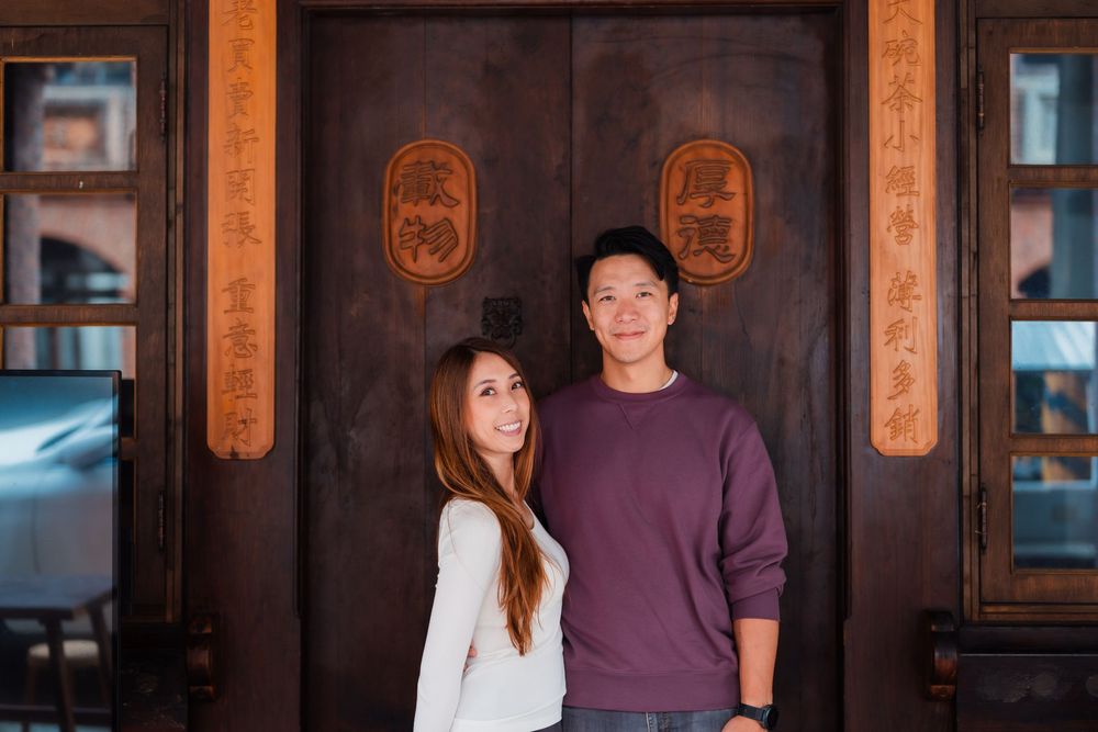 A couple in front of a traditional wooden door at Dihua Street in Dadaocheng, Datong District, Taipei City.