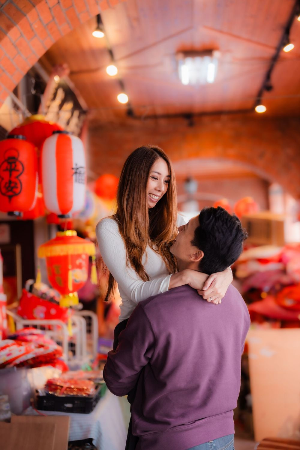 A couple shares an intimate moment at Dihua Street in Dadaocheng, Datong District, Taipei.