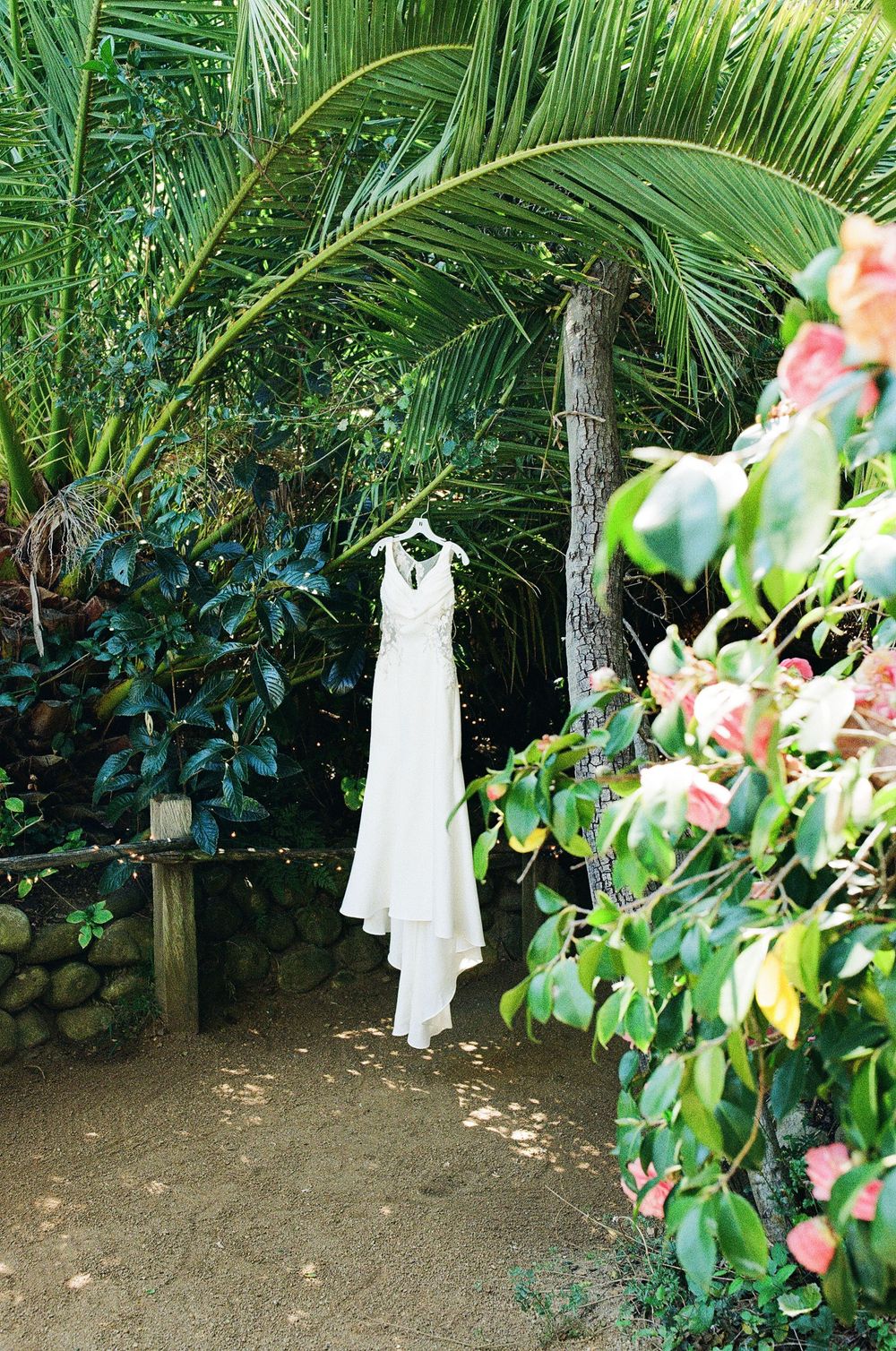Wedding dress hangs at California wedding venue photographed on 35mm film. Inspiration for garden weddings in NC and Charlotte area.
