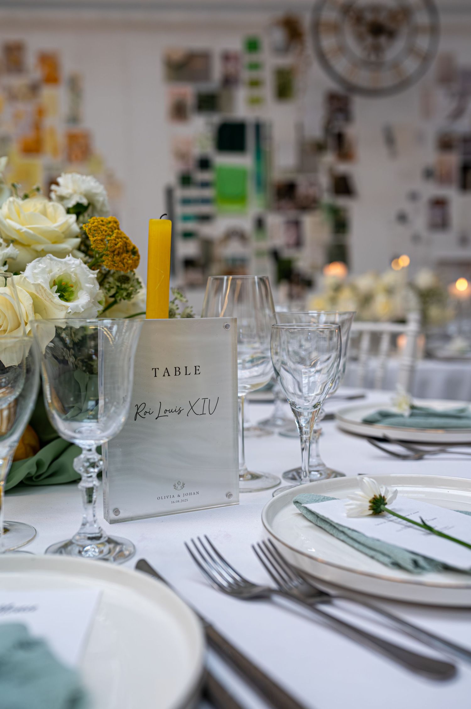 Cadre de table de mariage élégant avec des roses blanches, une bougie jaune, des verres en cristal et un signe de table en marbre Roi Louis