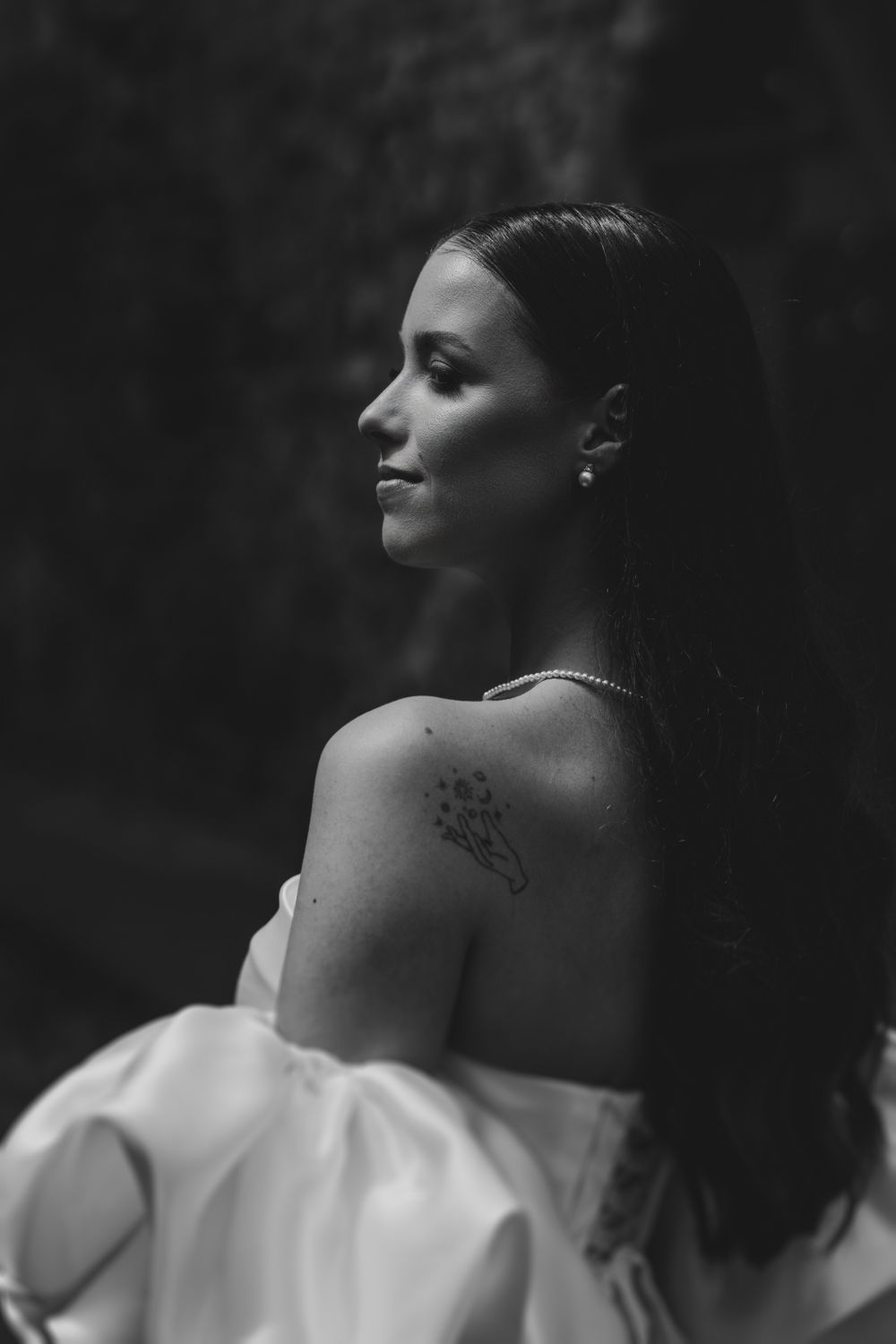 Dramatic black and white portrait showcasing elegant bridal details and jewelry.