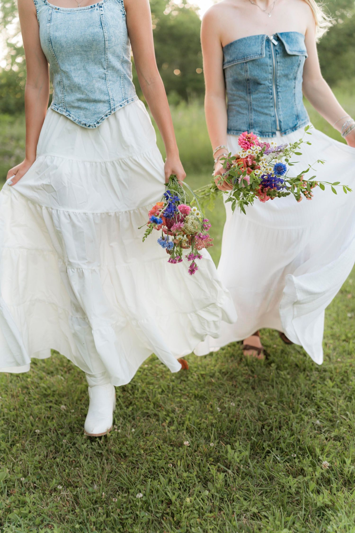 A series of photos showing white dress skirts with denim tops twirling in a grassy field with colorful wildflower bouquets.