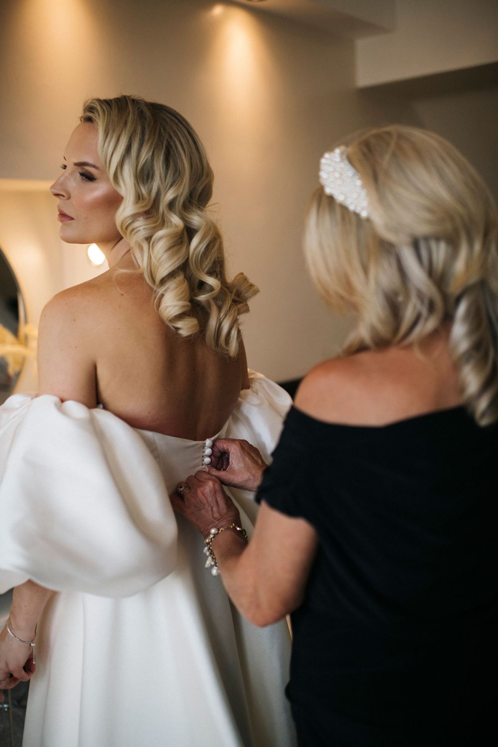 Wedding preparation sequence showing details of white bridal gown and styling.