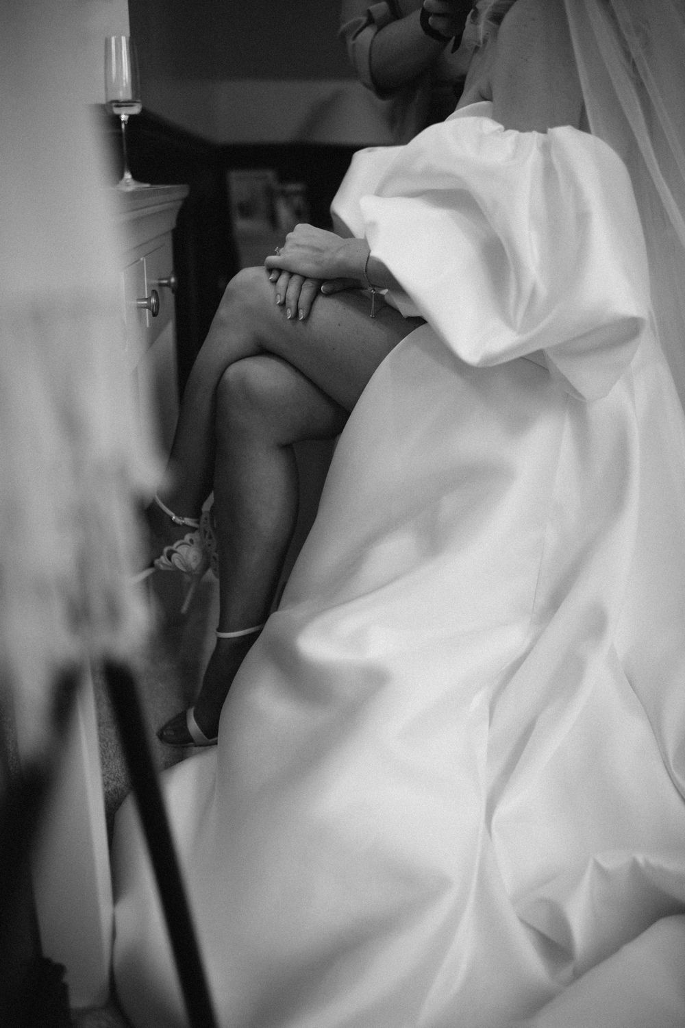 Artistic black and white close-up shots of a flowing white wedding dress in motion.