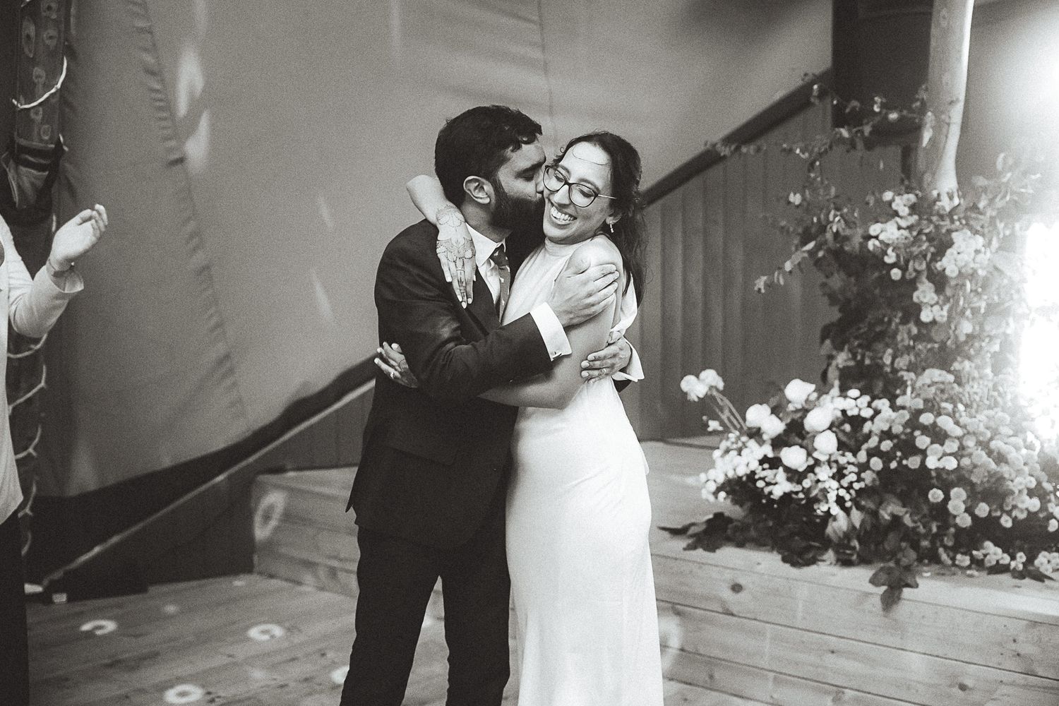 A series of black and white wedding photos showing romantic moments between a couple during their special day.