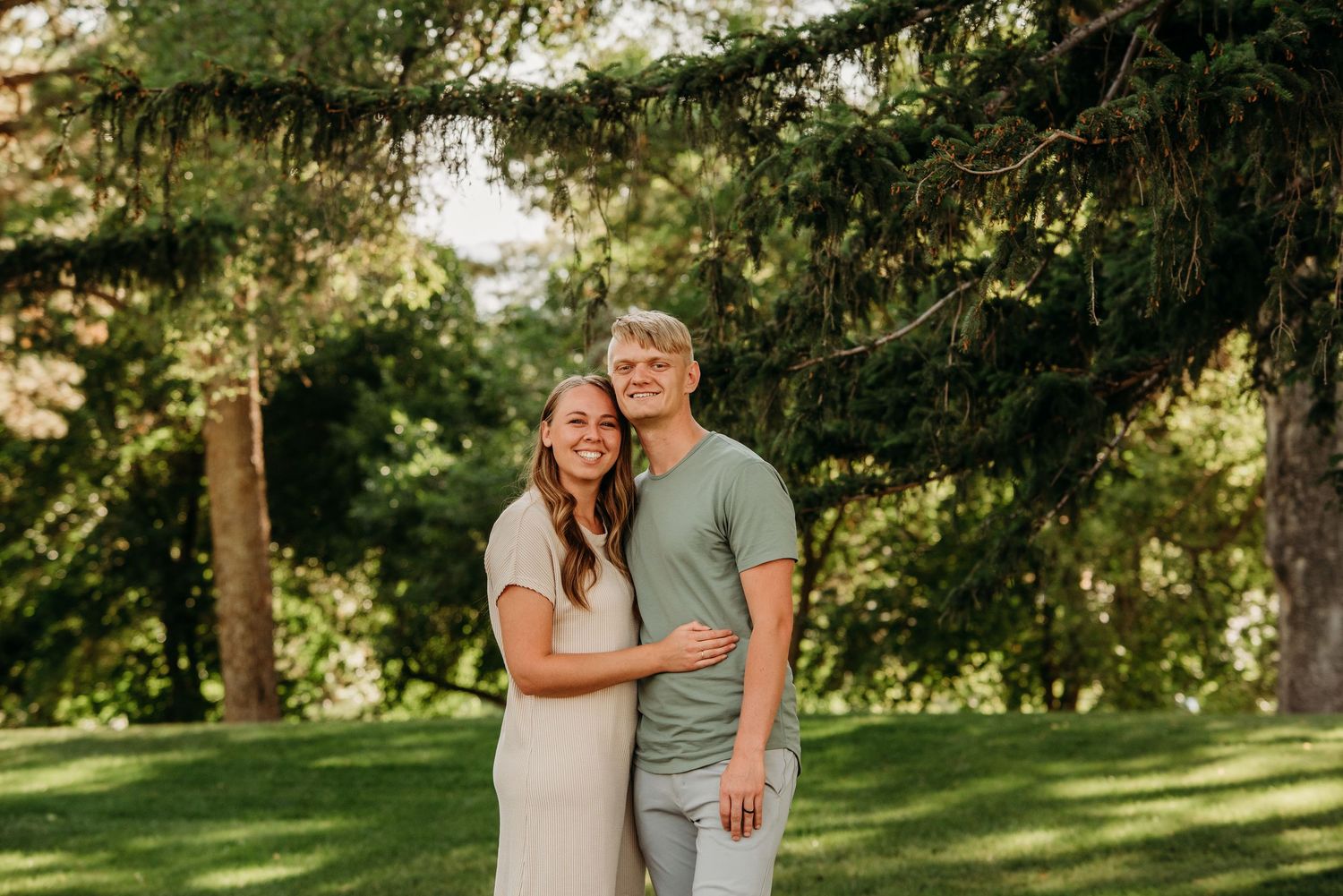 Couple enjoying scenic mountain view surrounded by golden aspen trees in fall.