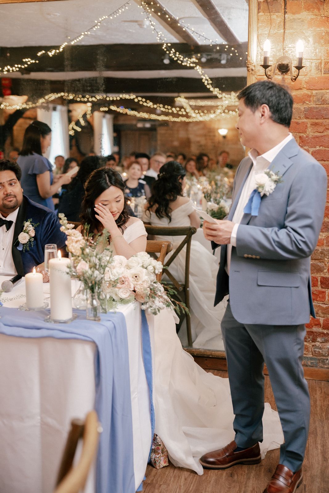 A grand historic mansion venue hosts an elegant wedding celebration with guests gathered on the grounds.