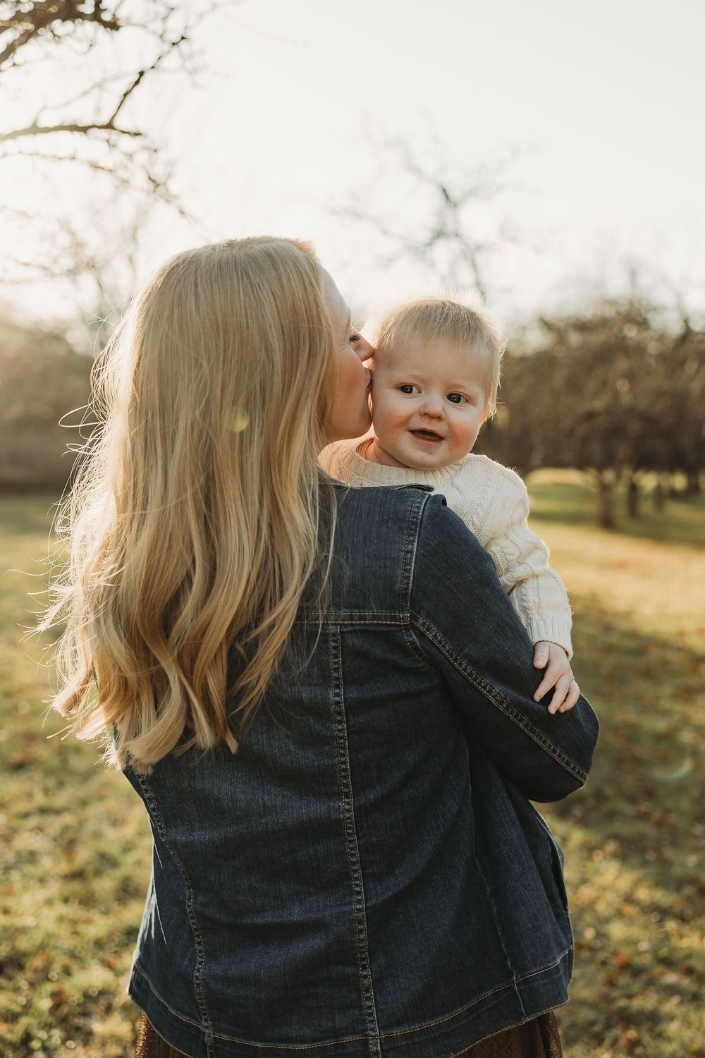 A series of tender moments captured between parent and child in a sunlit outdoor setting during autumn.