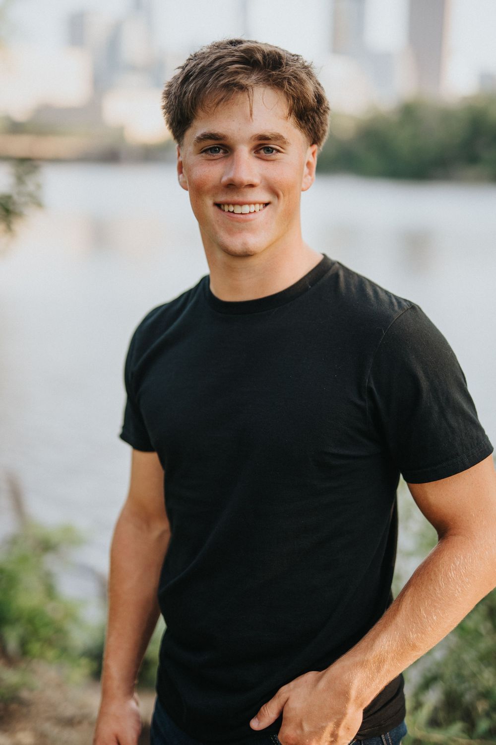 Series of waterfront portraits showing someone wearing a black t-shirt against an urban background.