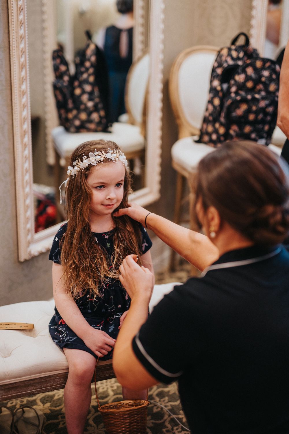 Wedding preparation scene in an elegant dressing room with ornate mirrors and soft lighting.