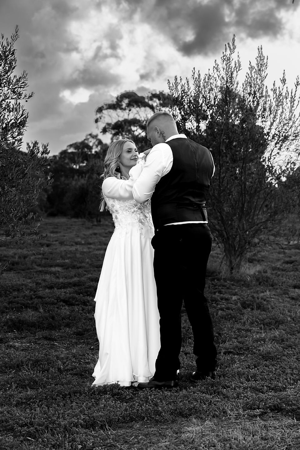 A black and white photo sequence shows a couple dancing together on a hillside in formal wedding attire.