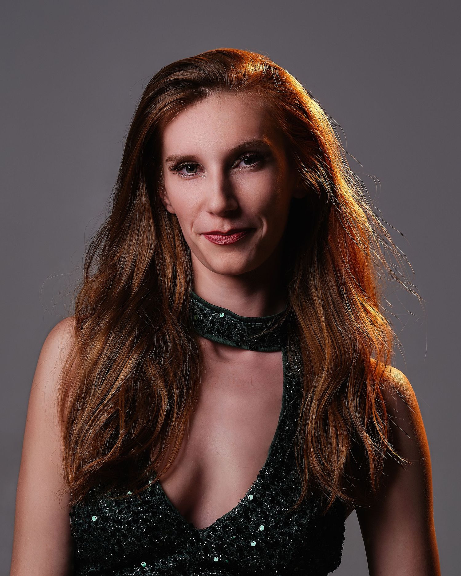 David G Holt Photography - Fashion portrait with metallic dress against colorful blue and red lighting backdrop.