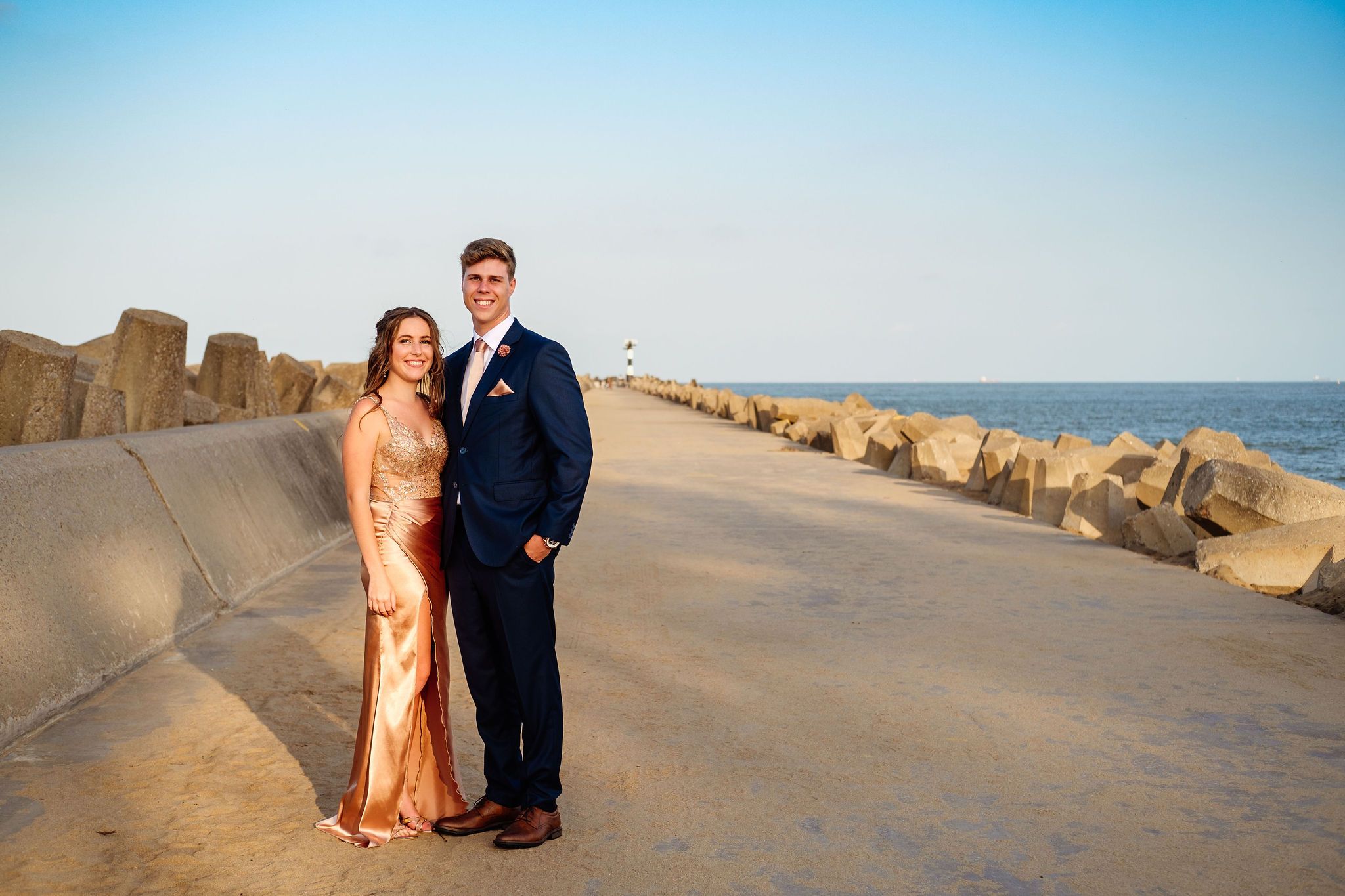 Matric farewell couple photographed on a pier at the beach