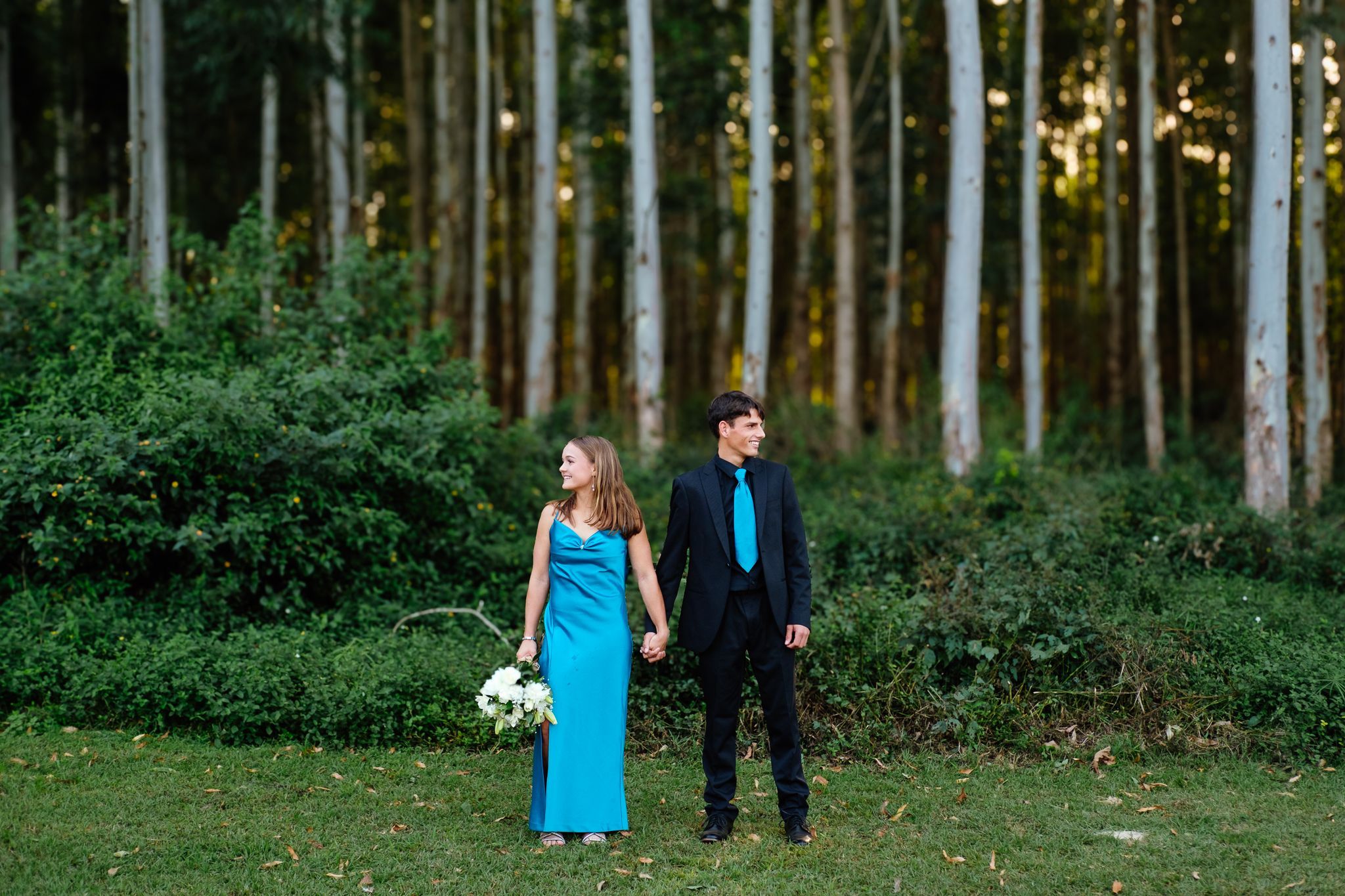 Matric farewell couple posing in front of a plantation landscape