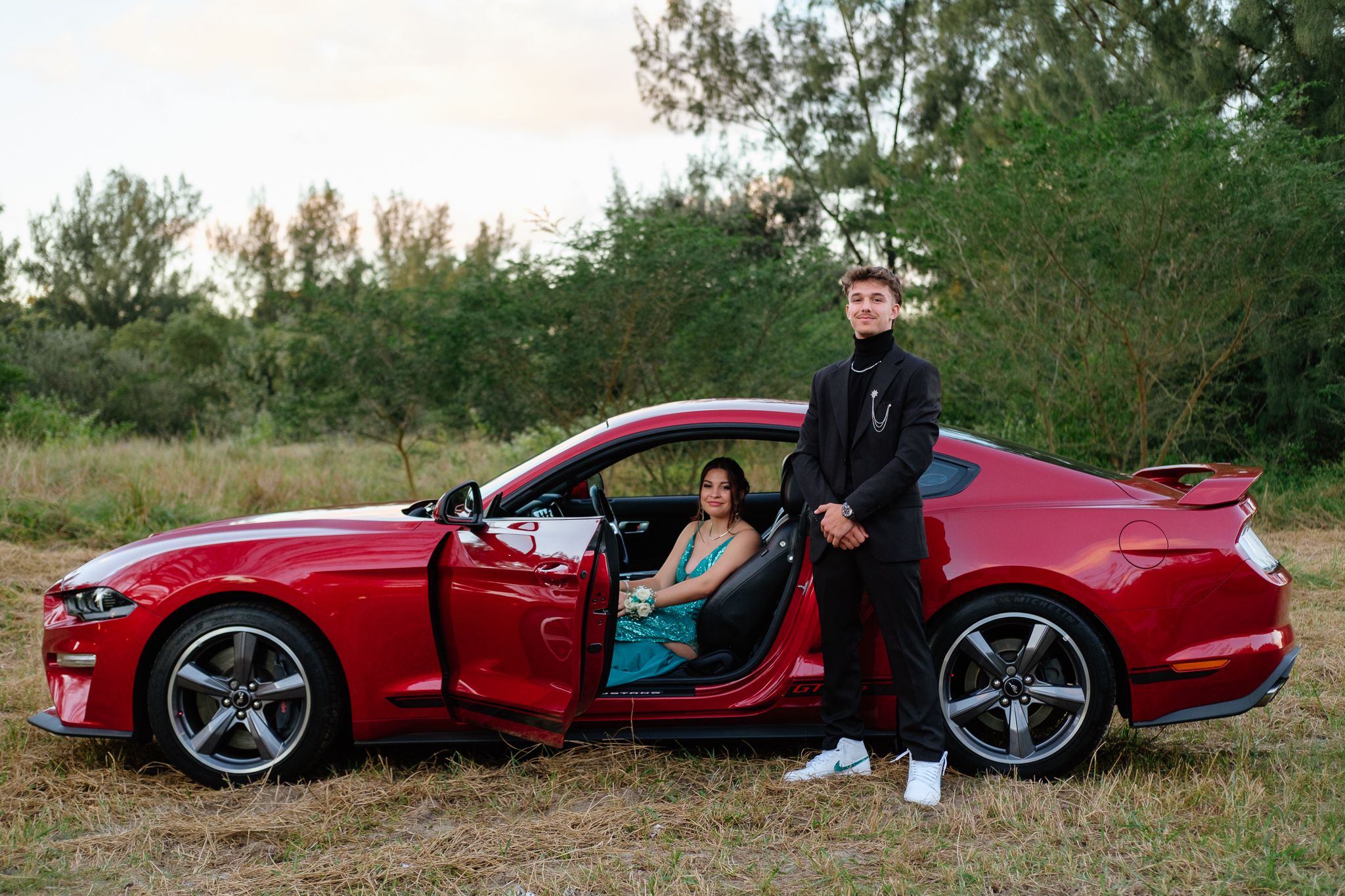 Matric farewell couple posing with their car during a photoshoot