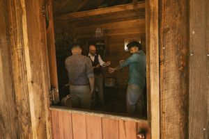 Interior view of rustic log cabin with wooden beams and walls.