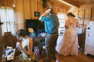 Interior of a rustic wooden cabin with natural light filtering through windows.
