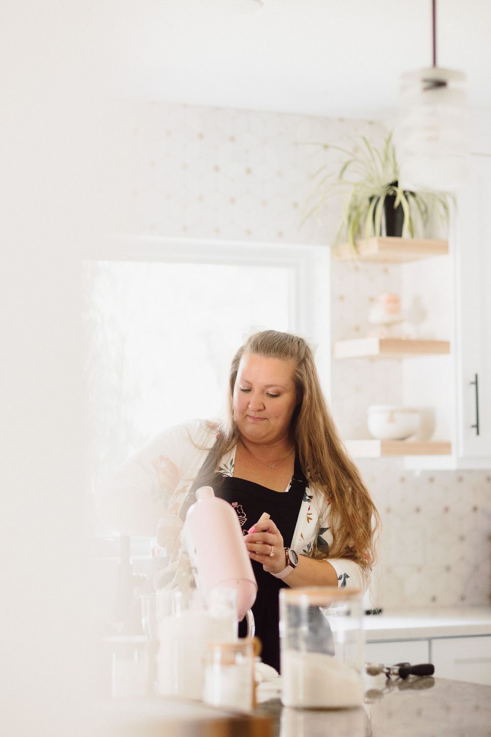 A sunlit kitchen scene with a pink stand mixer and baking activities.