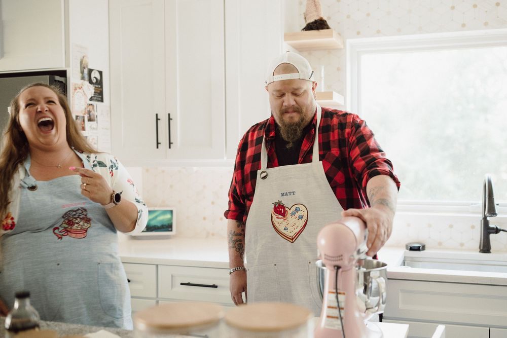 Family having fun and laughing while baking together in a bright modern kitchen.