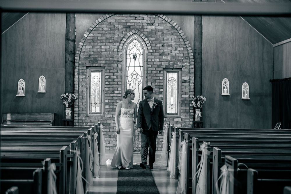 A series of black and white photos showing the interior of a traditional brick church with gothic windows and wooden pews.
