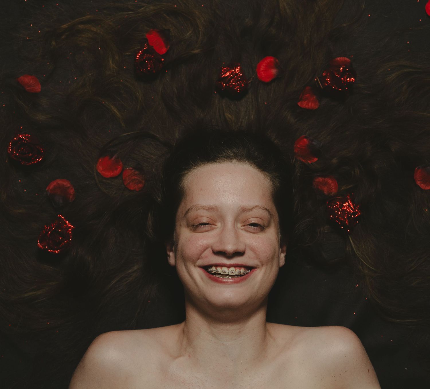 A series of four headshots showing different facial expressions and poses in a photo studio setting.