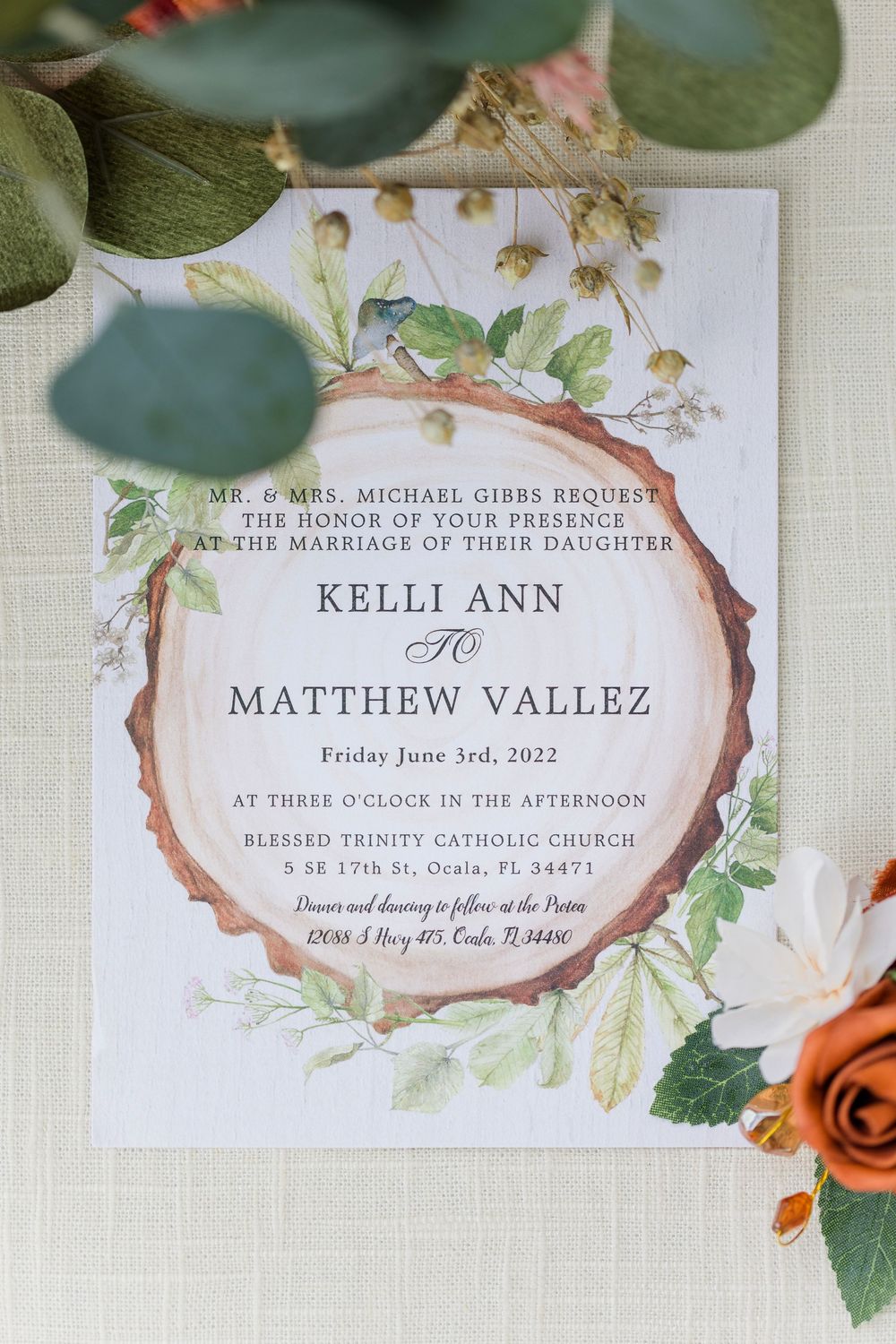 Elegant wedding invitation suite with floral watercolor design and green botanical details.