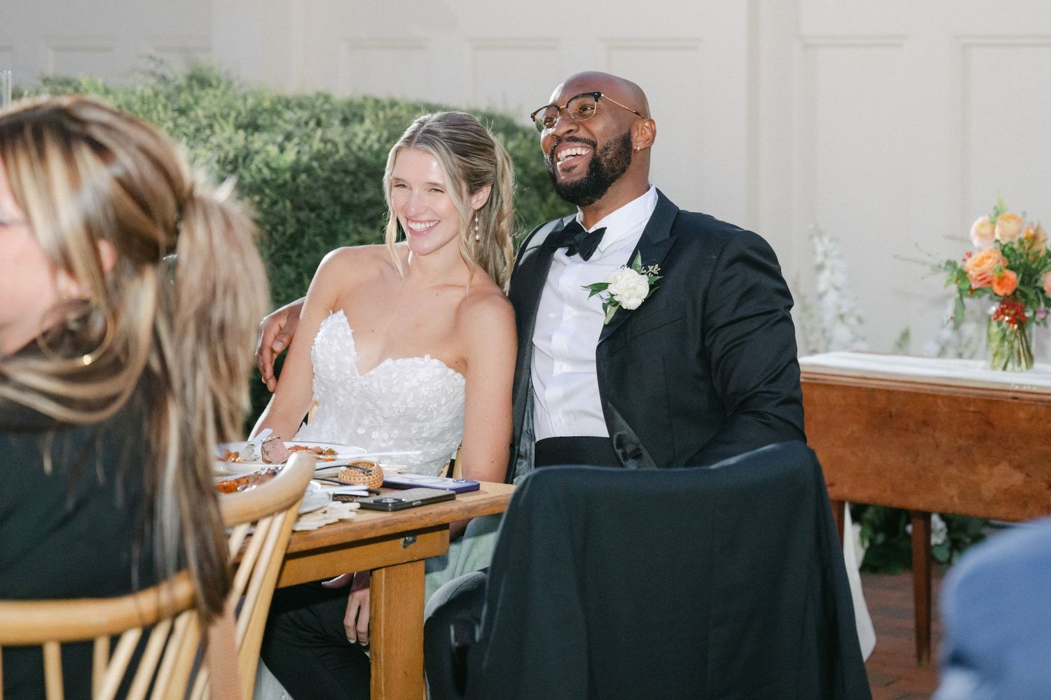 Couple sharing intimate moments during their wedding reception at a rustic outdoor venue. - Elawa Farm