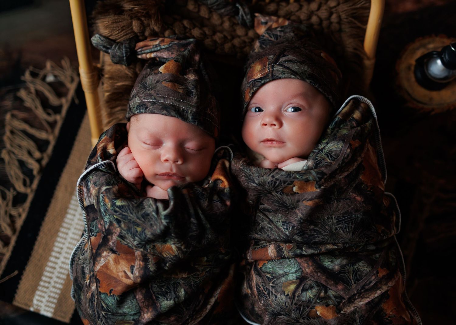 Twin newborn babies photographed with custom styling during a studio session in Attica Michigan