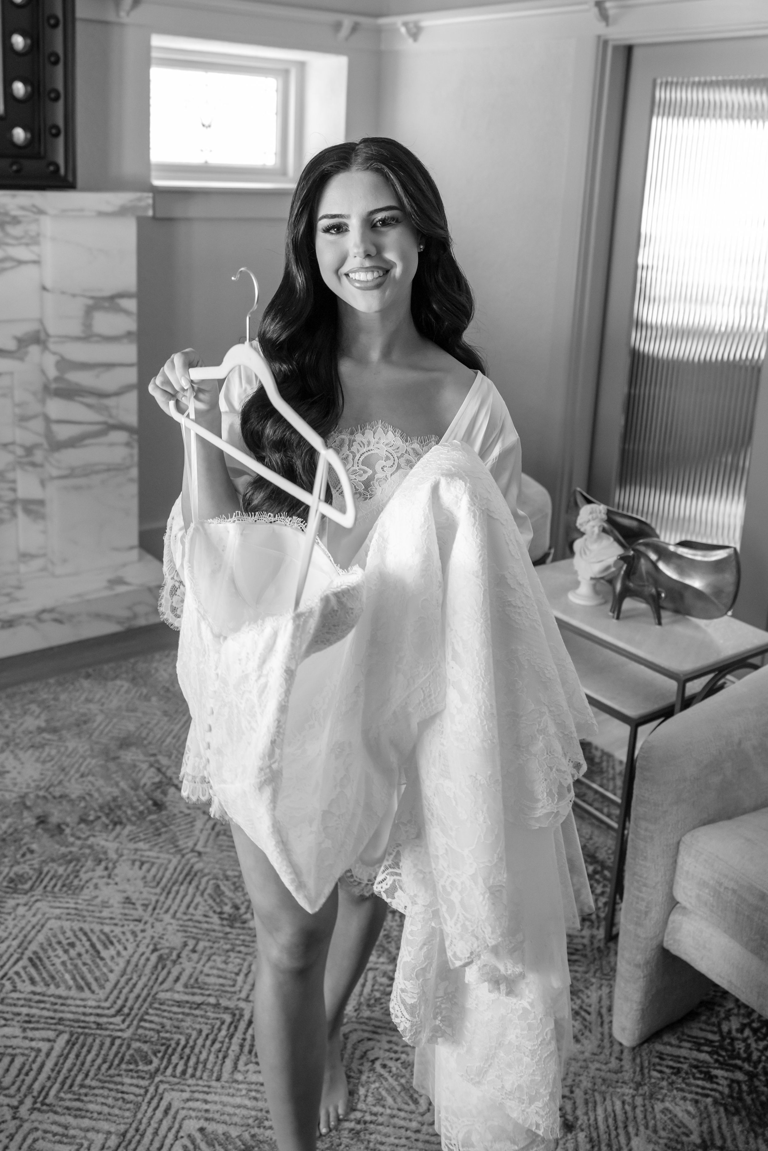 Wedding preparation scene showing white bridal gown in modern interior setting.