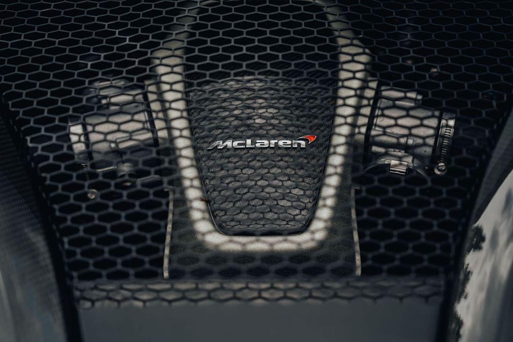 Black and white macro photograph of a metallic mesh pattern with shallow depth of field.