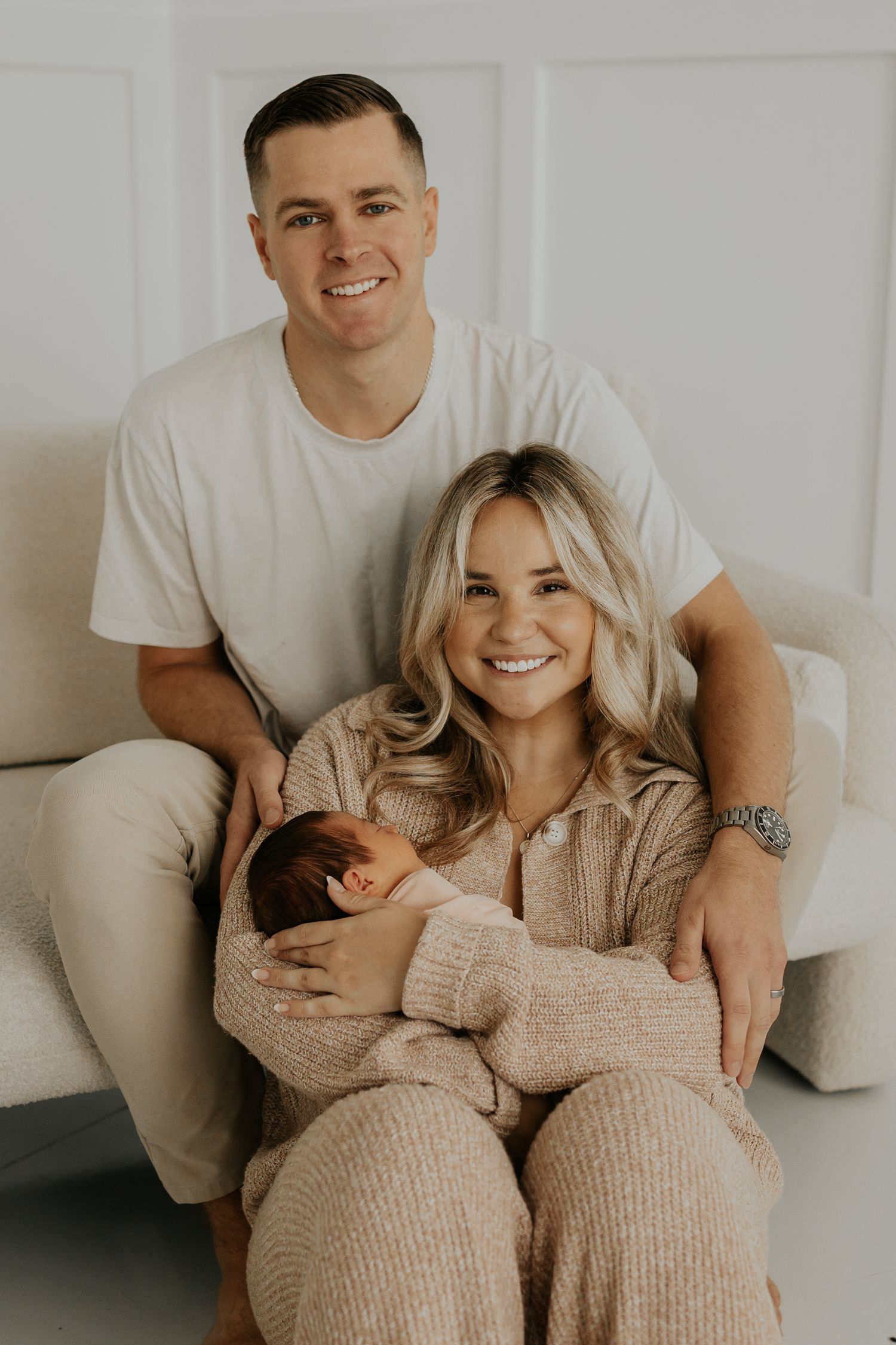 Family cuddles during cozy fall studio newborn session in Farmington MN.