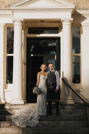A wedding couple stands in front of Washingborough Hall - taken by Grimsby photographer.