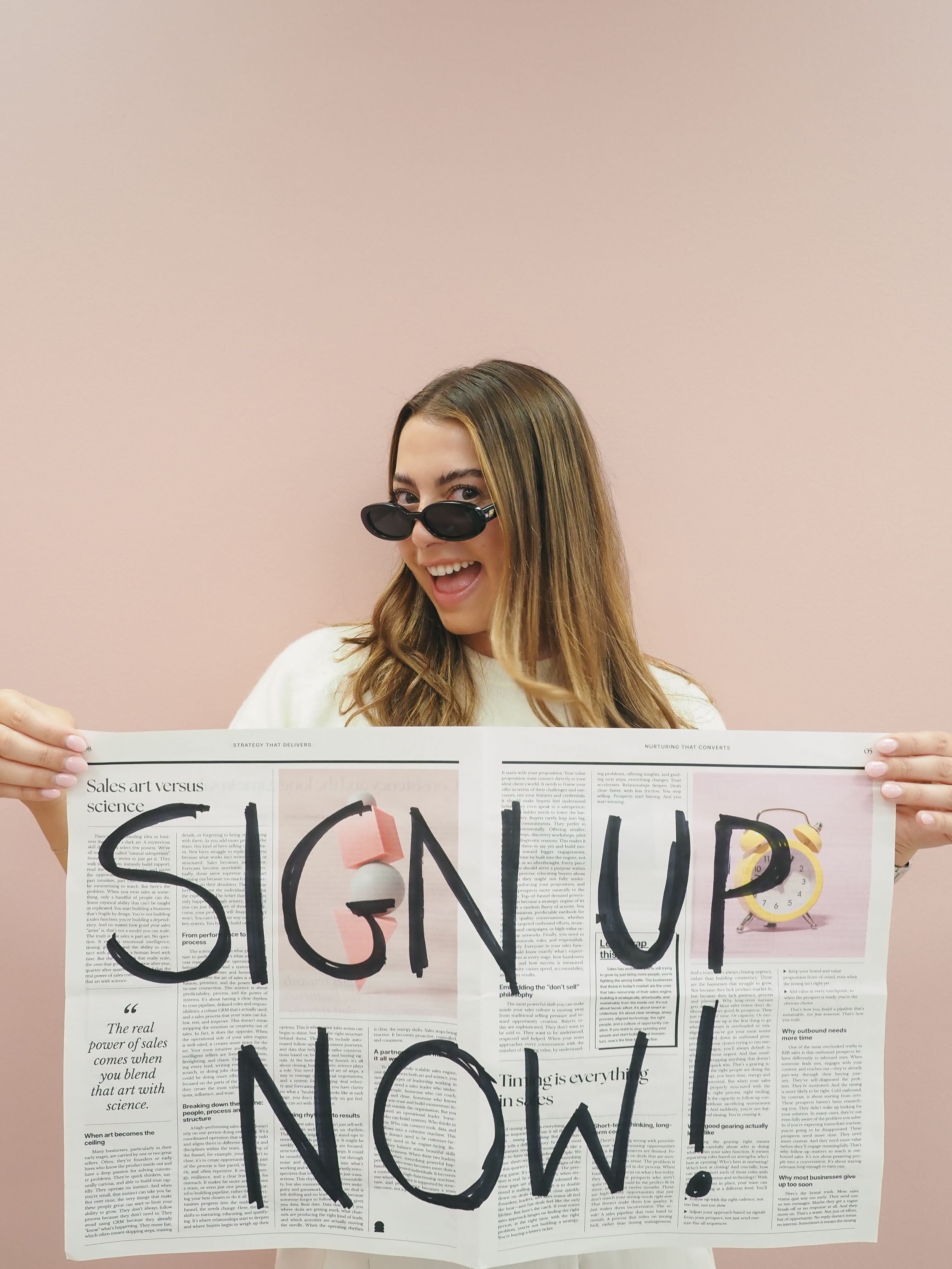 A creative five-panel photo sequence shows someone holding up newspaper sections to spell out 'SIGN UP NOW'.