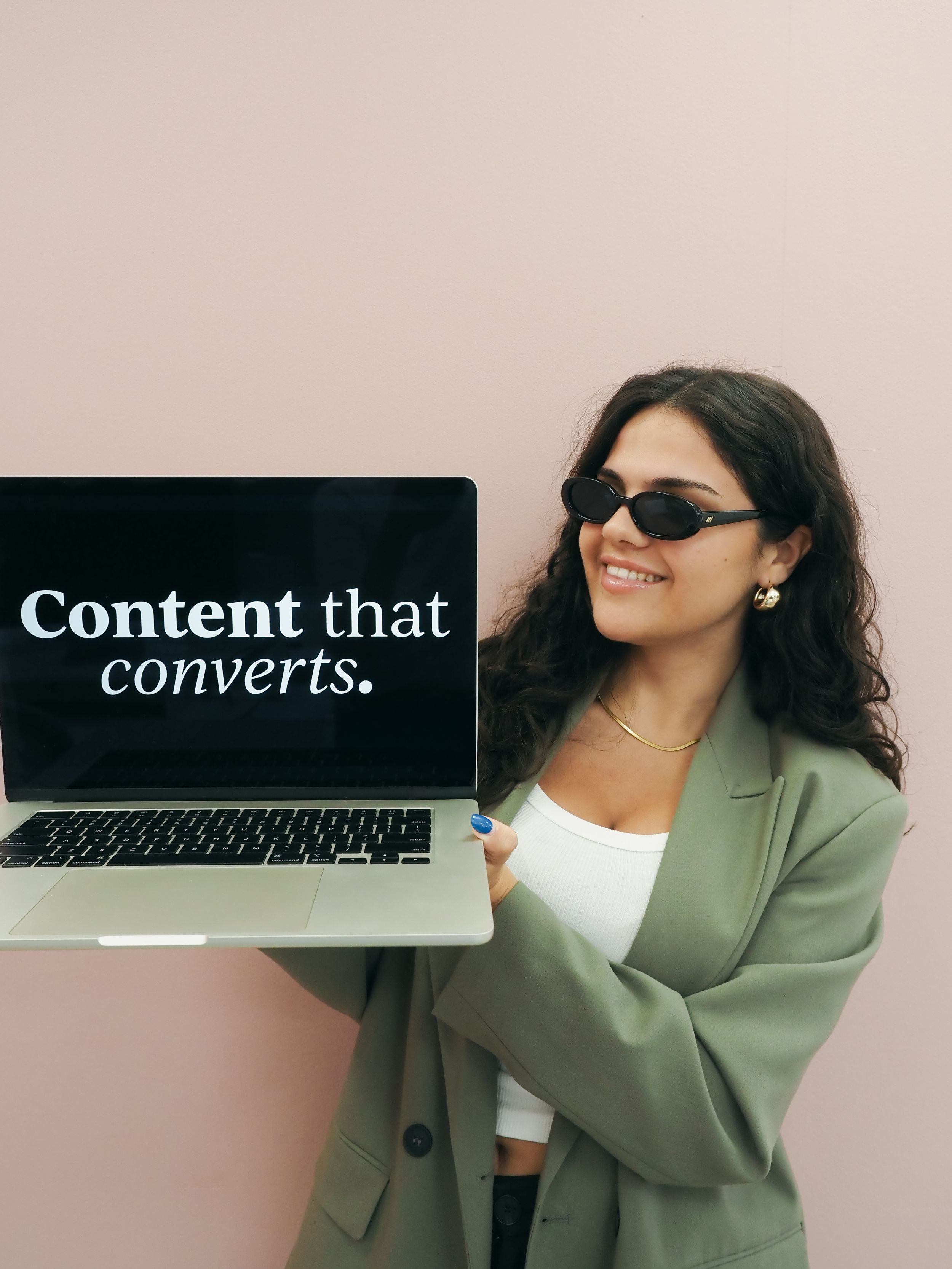 Minimalist collage featuring text 'Content that converts' with professional person in green blazer working at desk.