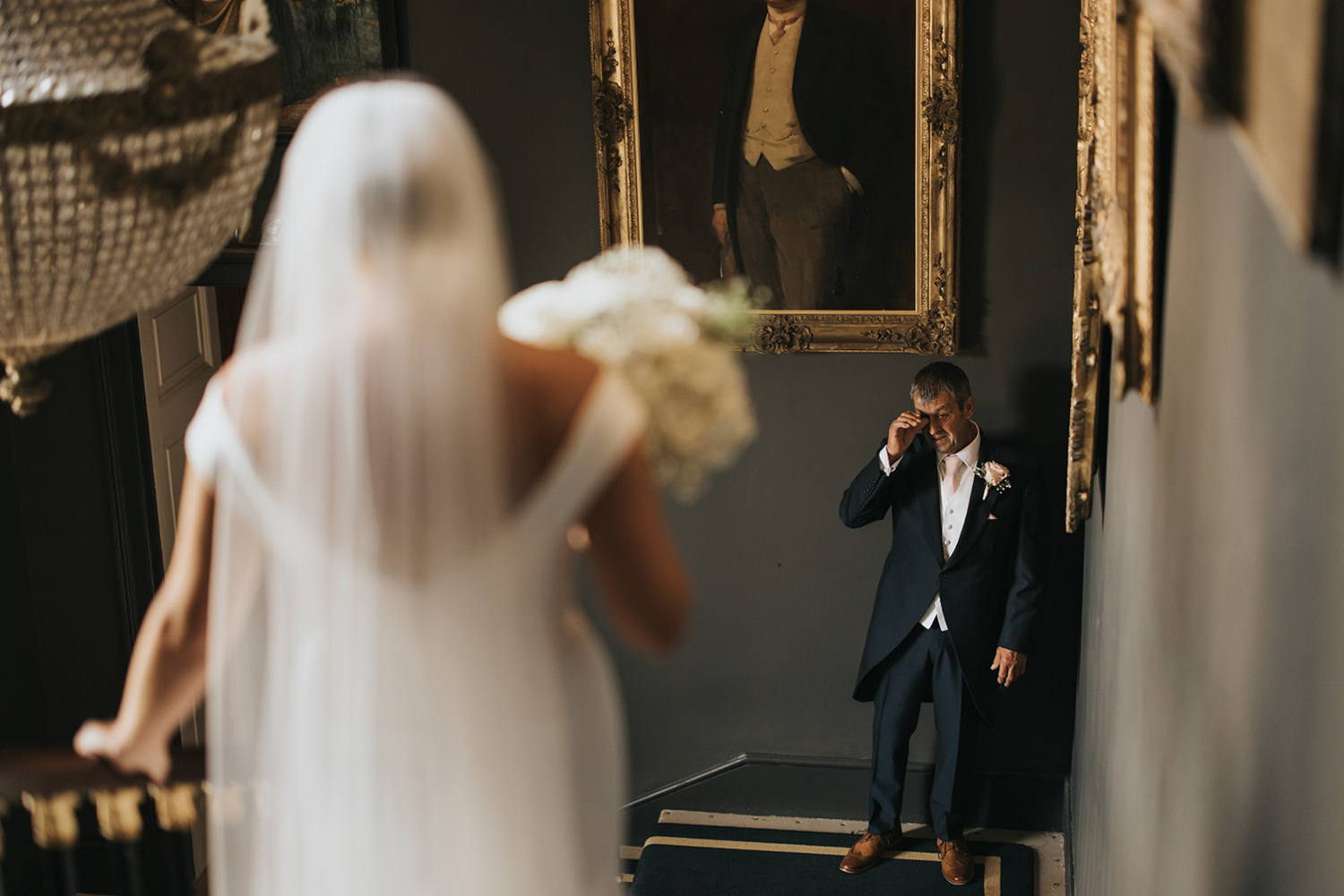 First look moment in stairwell between bride and father. Taken by Grimsby photographers.