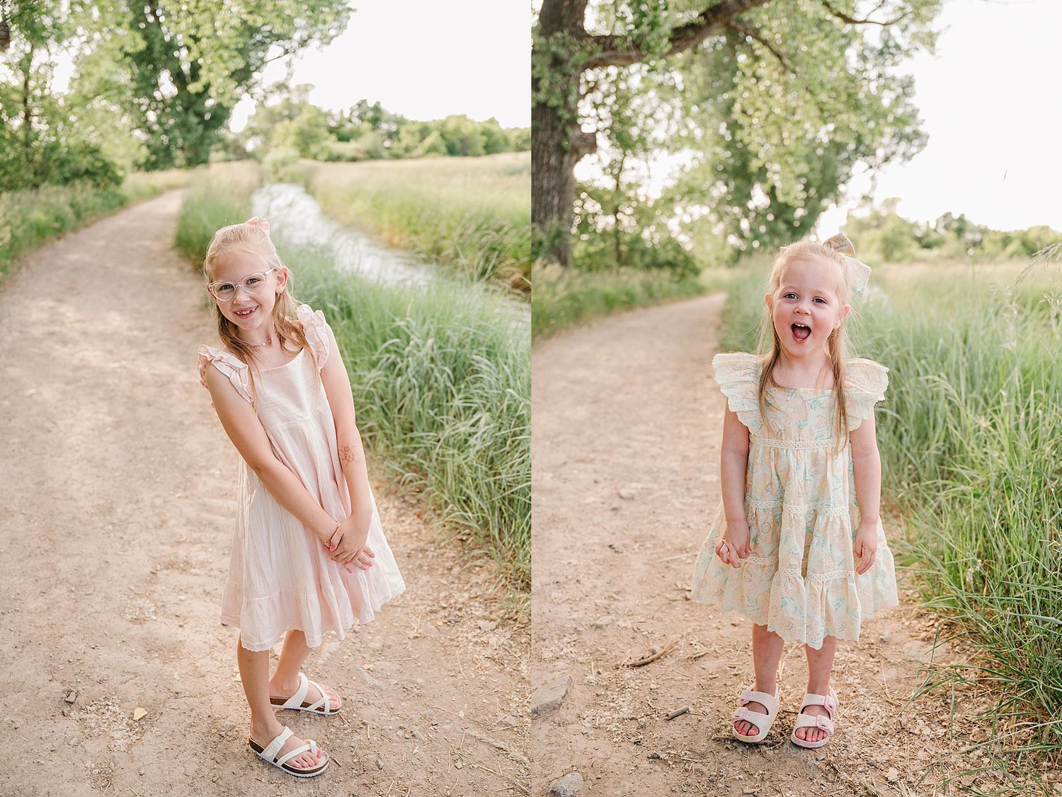 Young child in a summer dress with blonde hair poses playfully on a dirt path surrounded by green grass and trees.