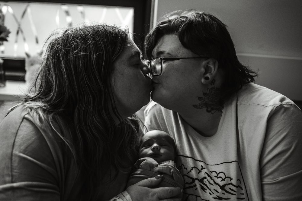 Intimate black and white photo of a romantic couple sharing a tender kiss.