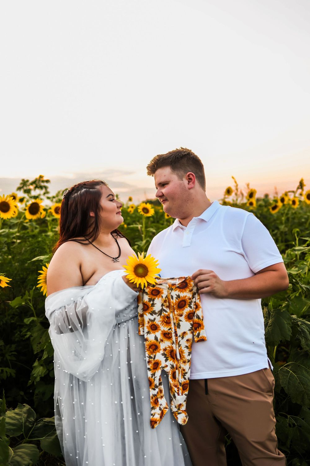 Couple shares tender moments in a vibrant sunflower field during golden hour, showcasing a series of romantic poses.