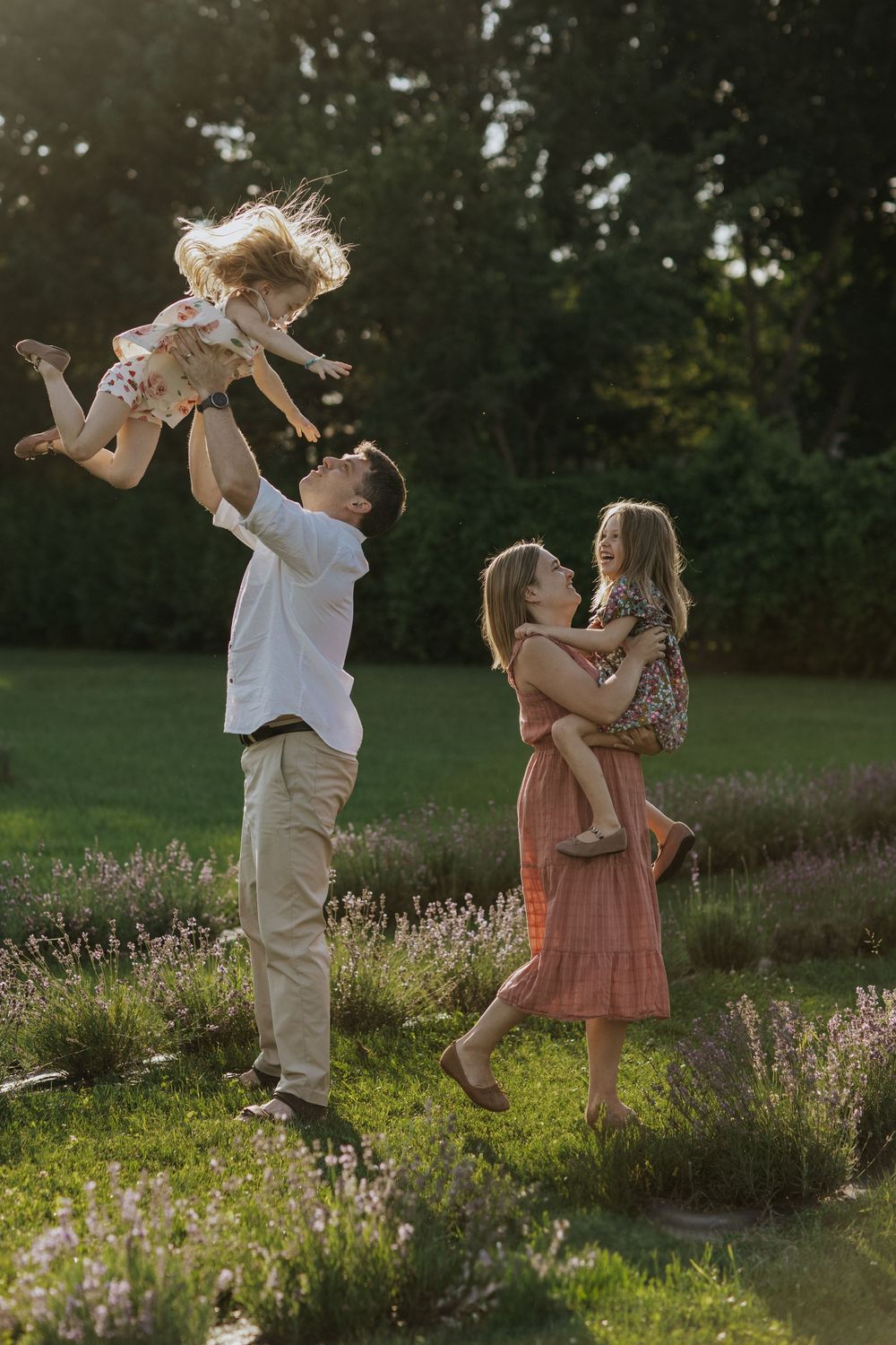 A loving moment shared between a family playing together in a lavender field near Ottawa,ON at sunset.