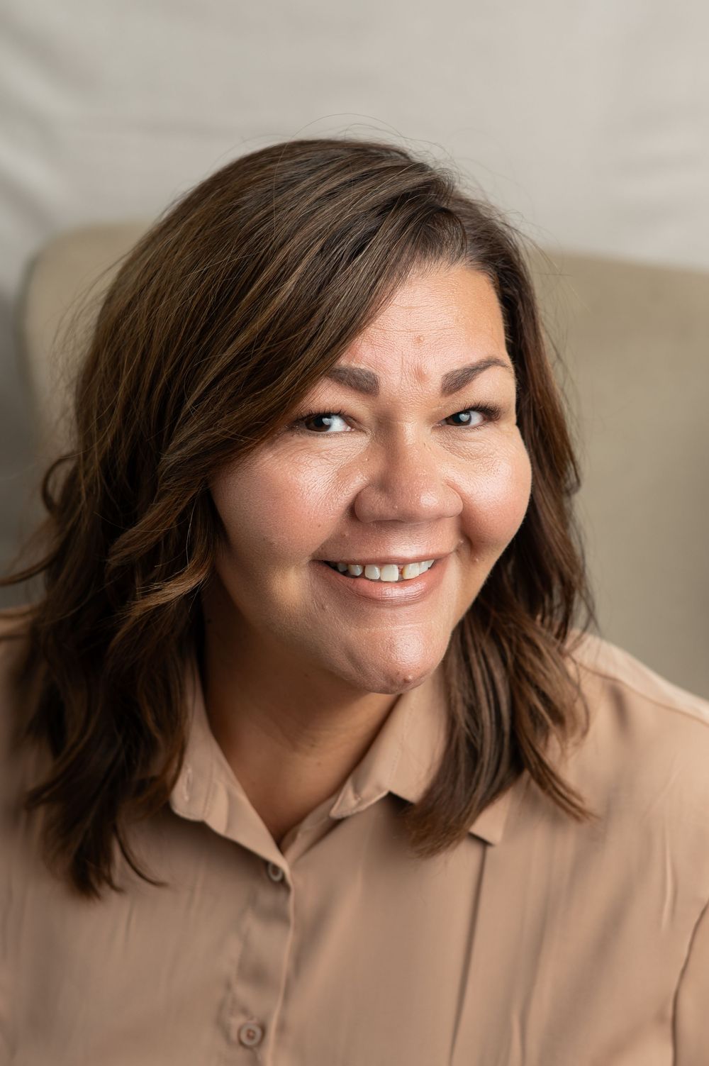 Series of close-up photos showing a person in a beige button-up top expressing different joyful emotions.