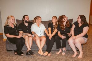 Group sitting together on the floor showing casual togetherness during a special occasion.