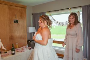 Interior view of a wedding prep room with gray curtains and wood paneling.